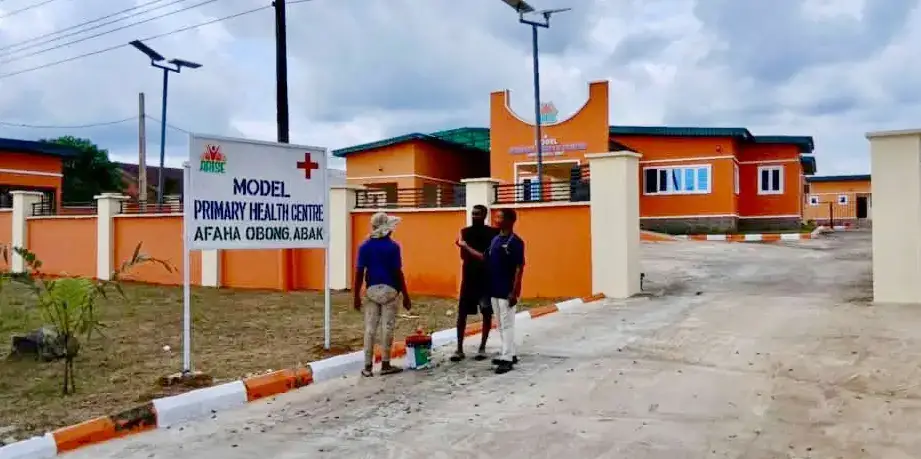 Signboard and buildings at the Model Primary Health Centre, Afaha Obong