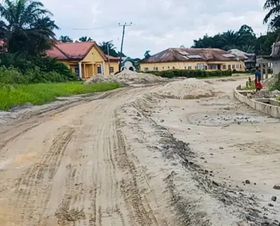 Graded road leading toward houses at the village edge