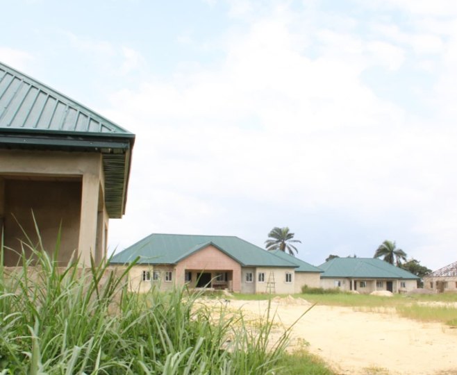 Roofed school buildings seen across open ground