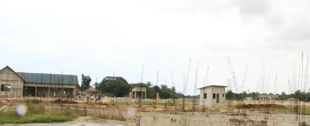 Wide view of the youth centre building site with rising columns