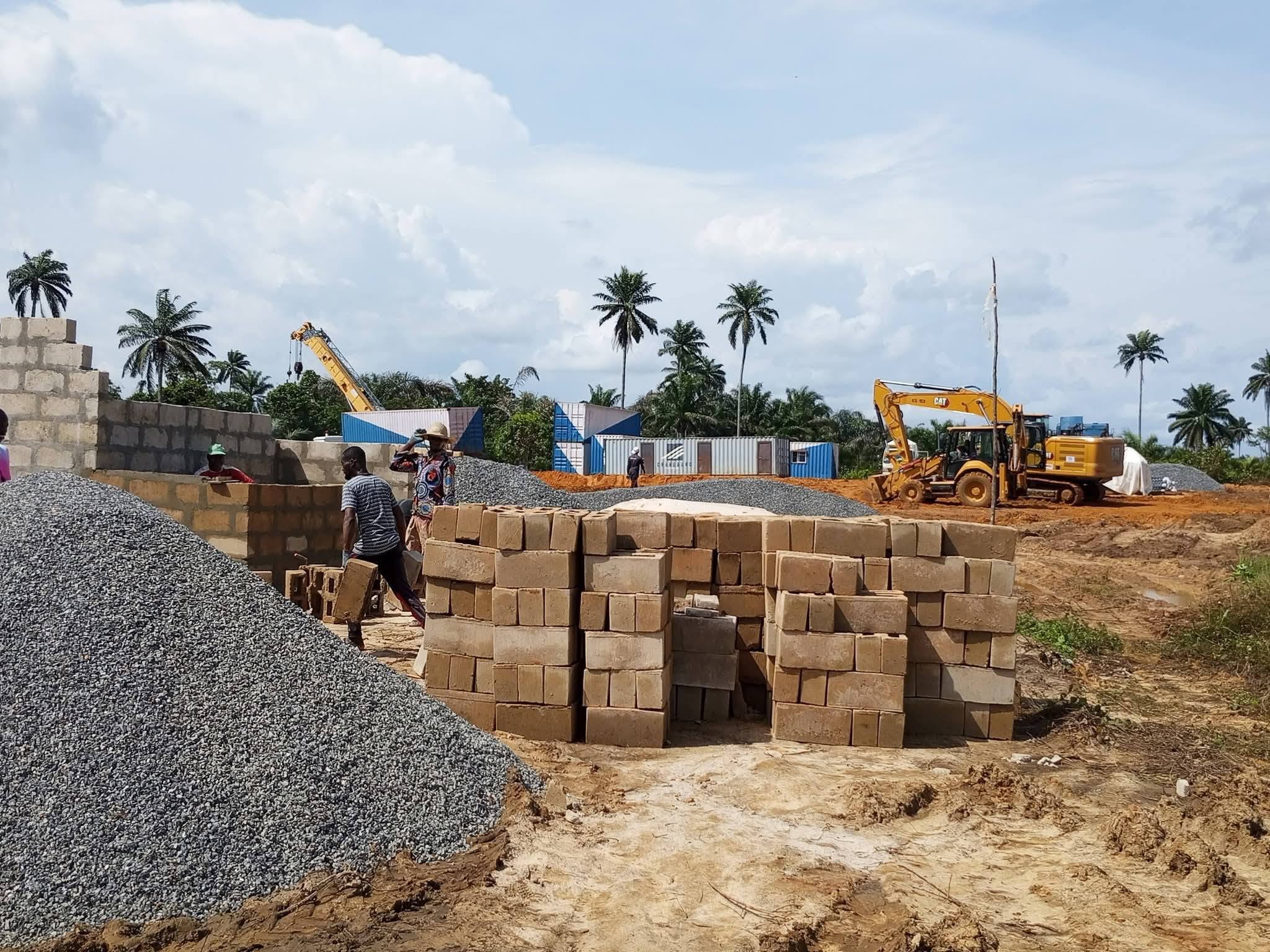 Blocks, stone and an excavator at the Ikwe-Odio Road site camp after mobilisation