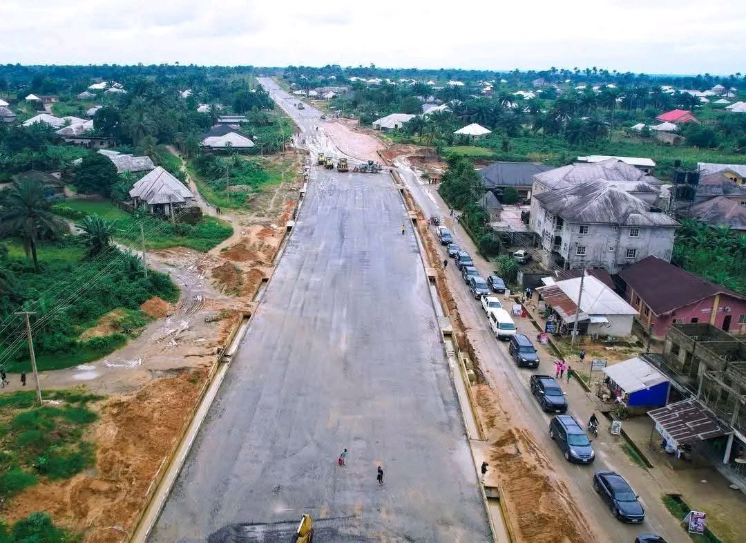 Drone view of the dual carriageway with prepared base and side drains running through the town, a public road alongside