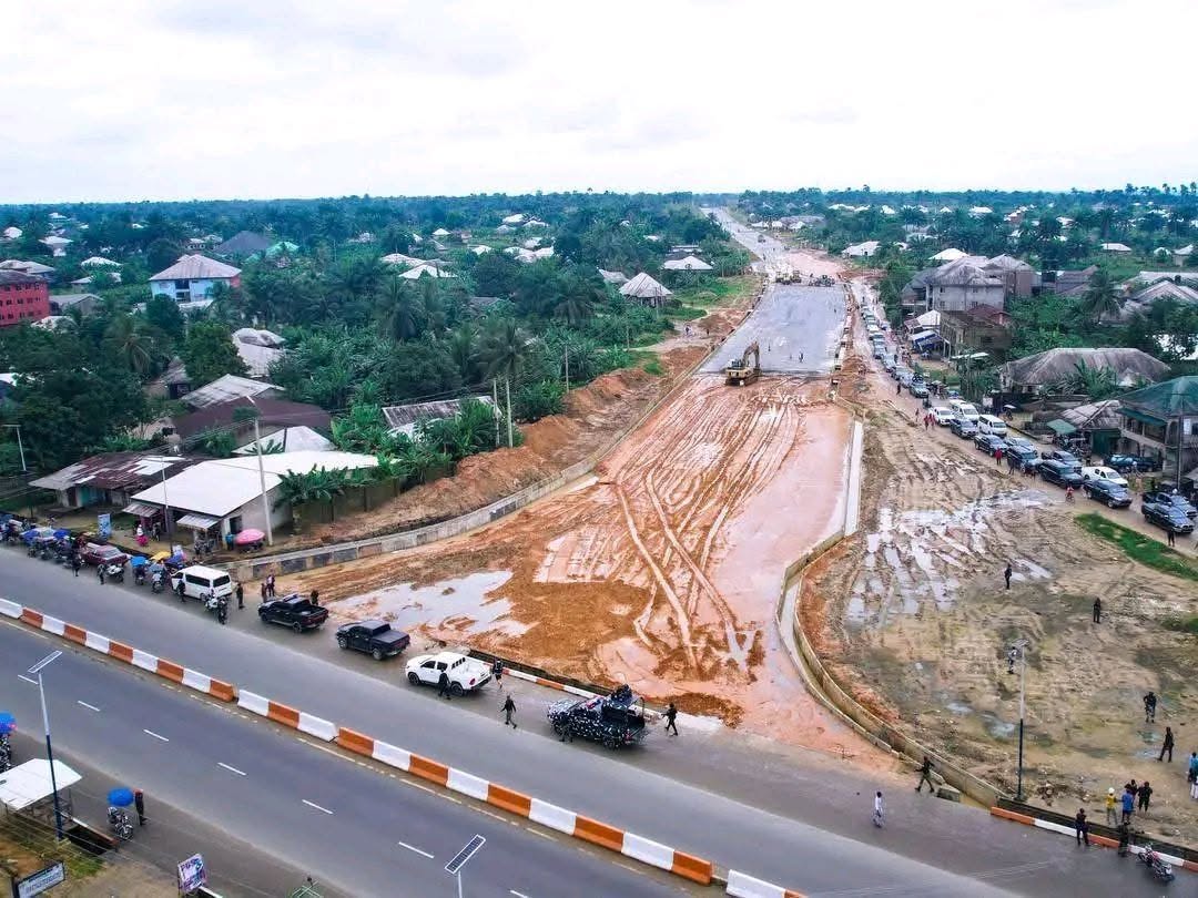 Drone view of the carriageway under construction meeting the existing road, with an excavator on the cleared route