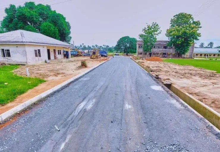 Newly paved access road running past school buildings