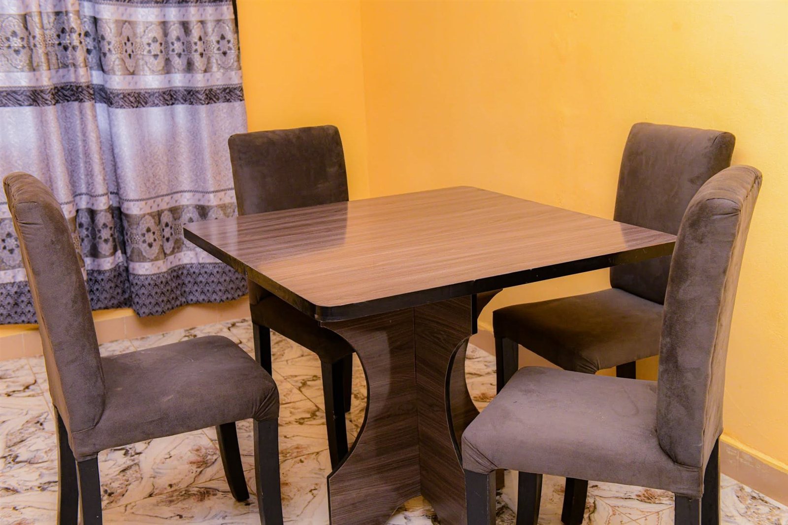 Dining table and chairs inside the new home