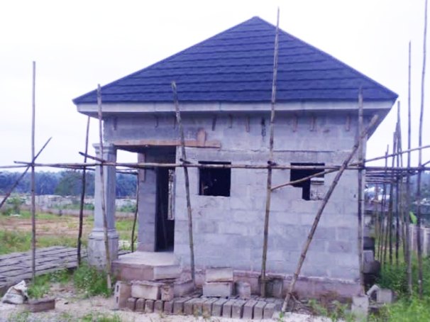 Small blue roofed gate house under construction on the site