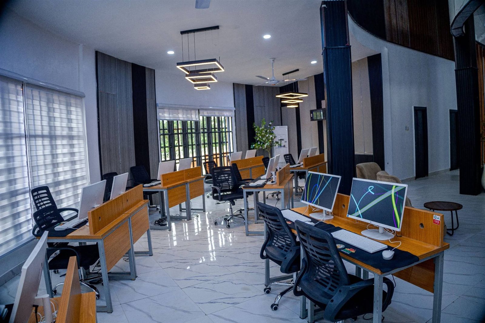 Computer training hall with rows of desks and new computers