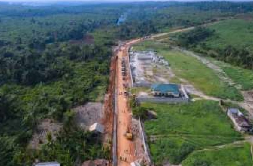 Aerial view of the road corridor cut through forest and farmland