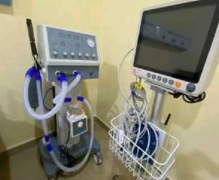 Ventilator and patient monitor on stands in the hospital
