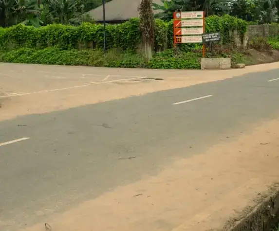 Commissioned road in Ika with a project signboard at the roadside