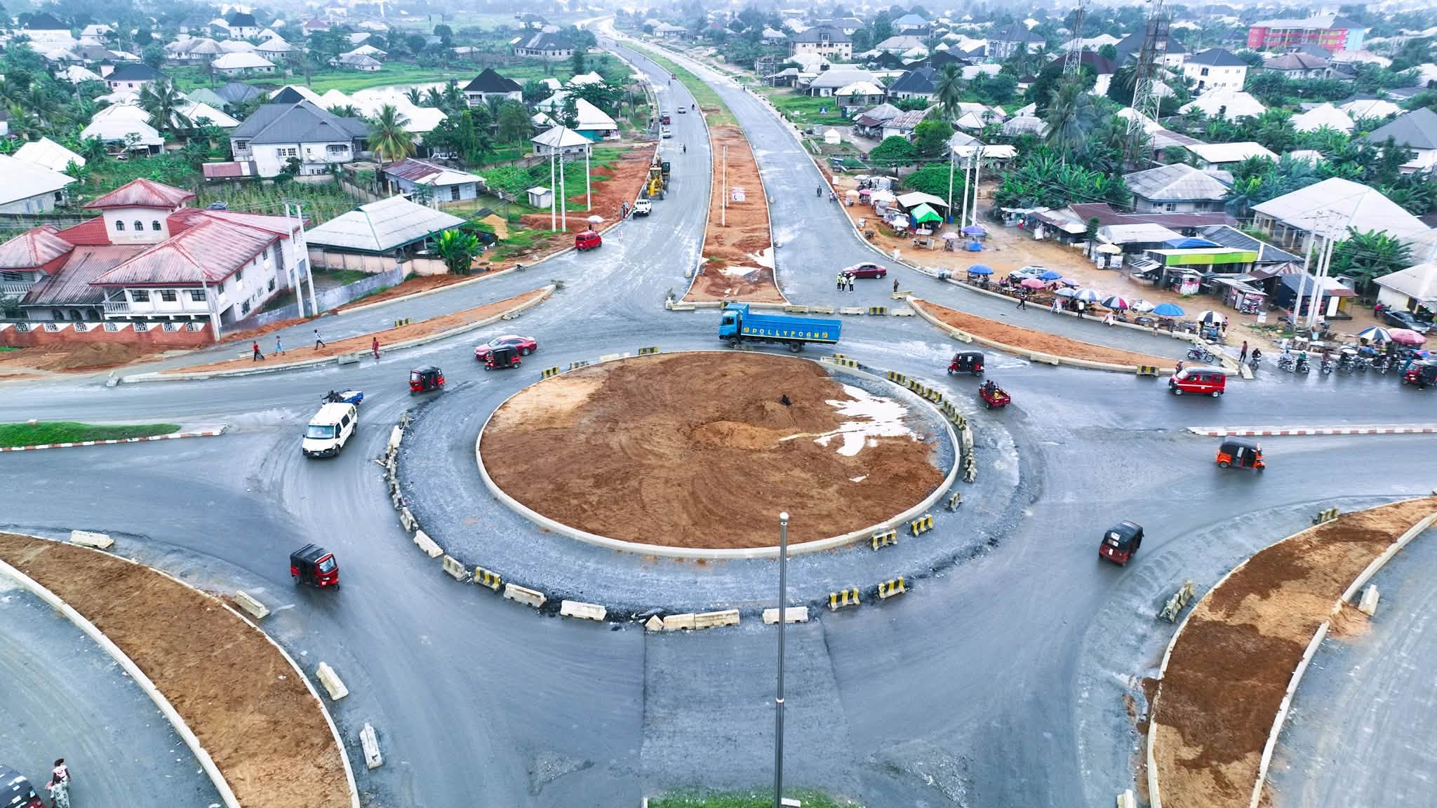 Aerial view of a large roundabout under construction where the dual carriageway meets a busy town road