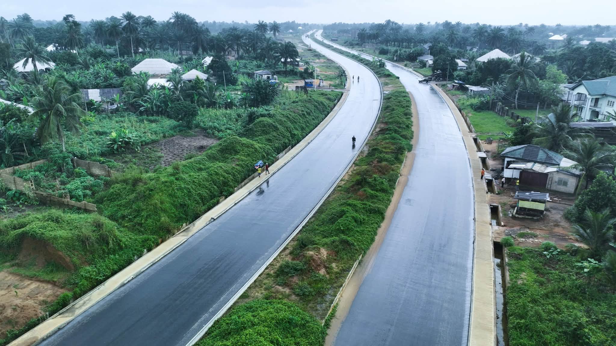 Aerial view of the finished asphalt dual carriageway with a green median and side drains