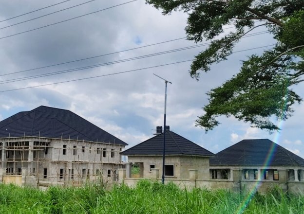 Chairman's residence blocks rising under new roofs, seen from the road
