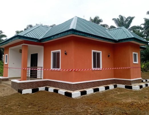 Newly built ARISE compassionate home with orange walls and green roof