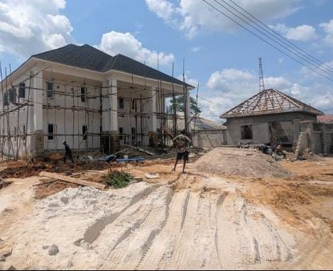 Chairman's lodge walls and first floor going up on a sandy site