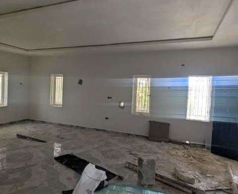 Unfinished interior hall of the Chairman's lodge with window openings