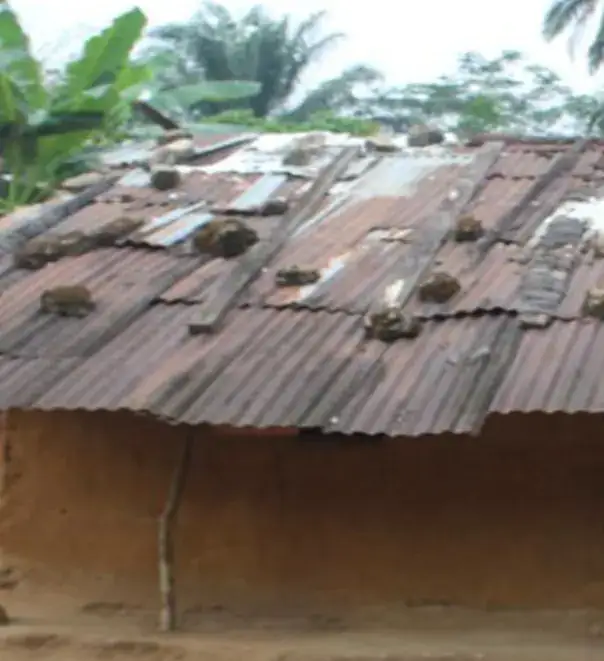 Zinc-roofed mud house before a compassionate home was built