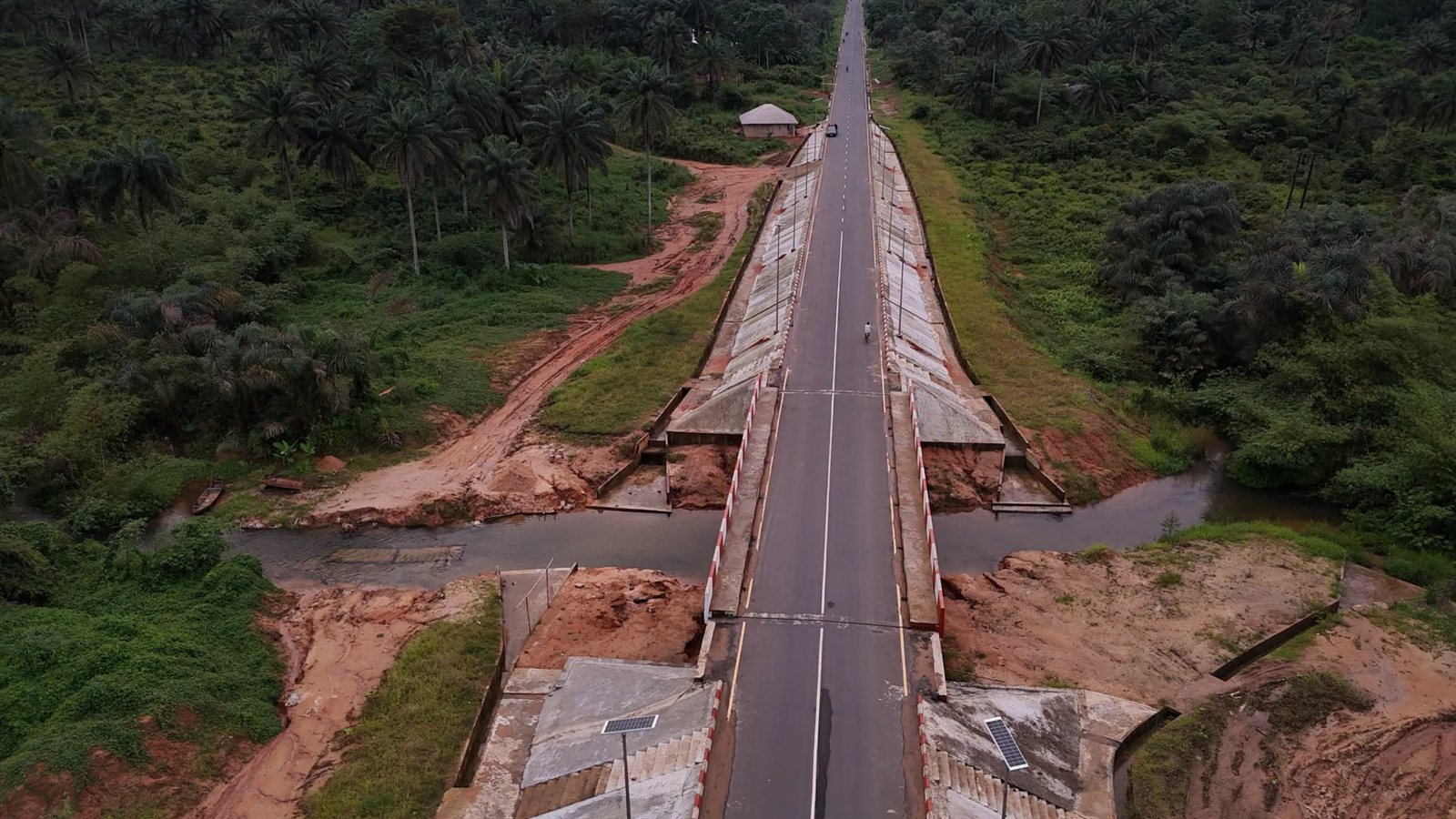 Aerial view of the road crossing the bridge over a stream