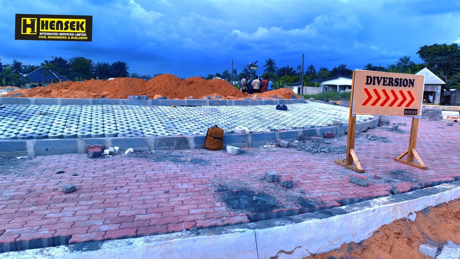 Interlocking paver works beside a diversion sign