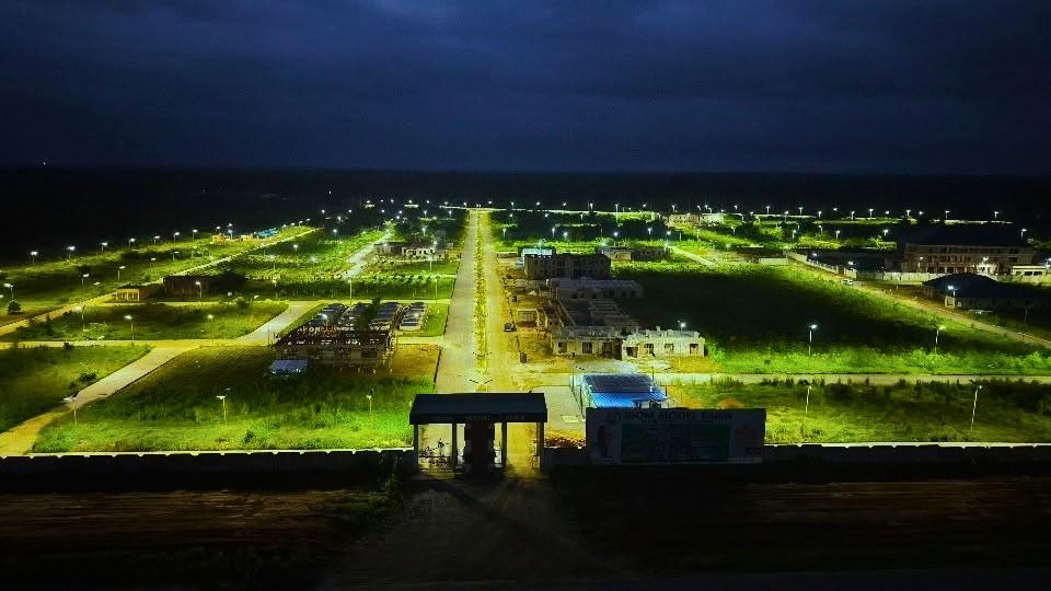 The farm grounds lit at night, seen from above