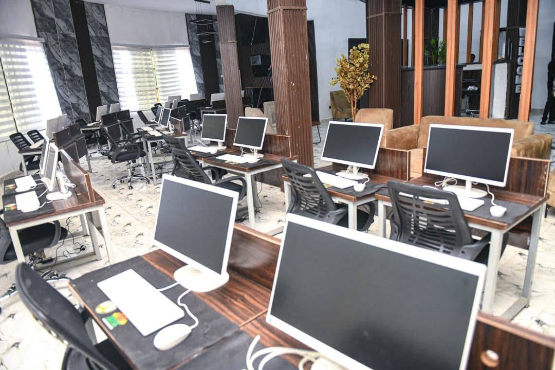 Computer room inside the centre with desktop computers on desks