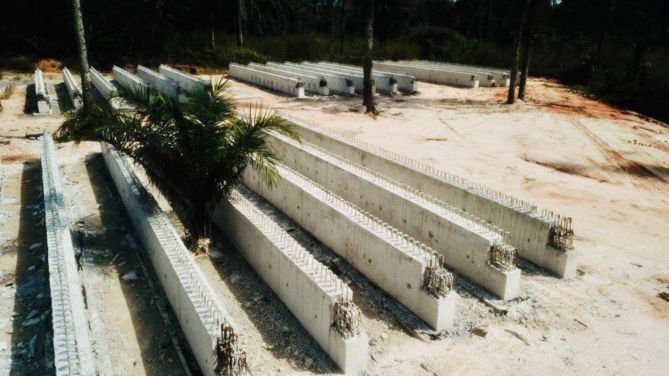 Rows of precast concrete bridge beams laid out on the casting yard near the site