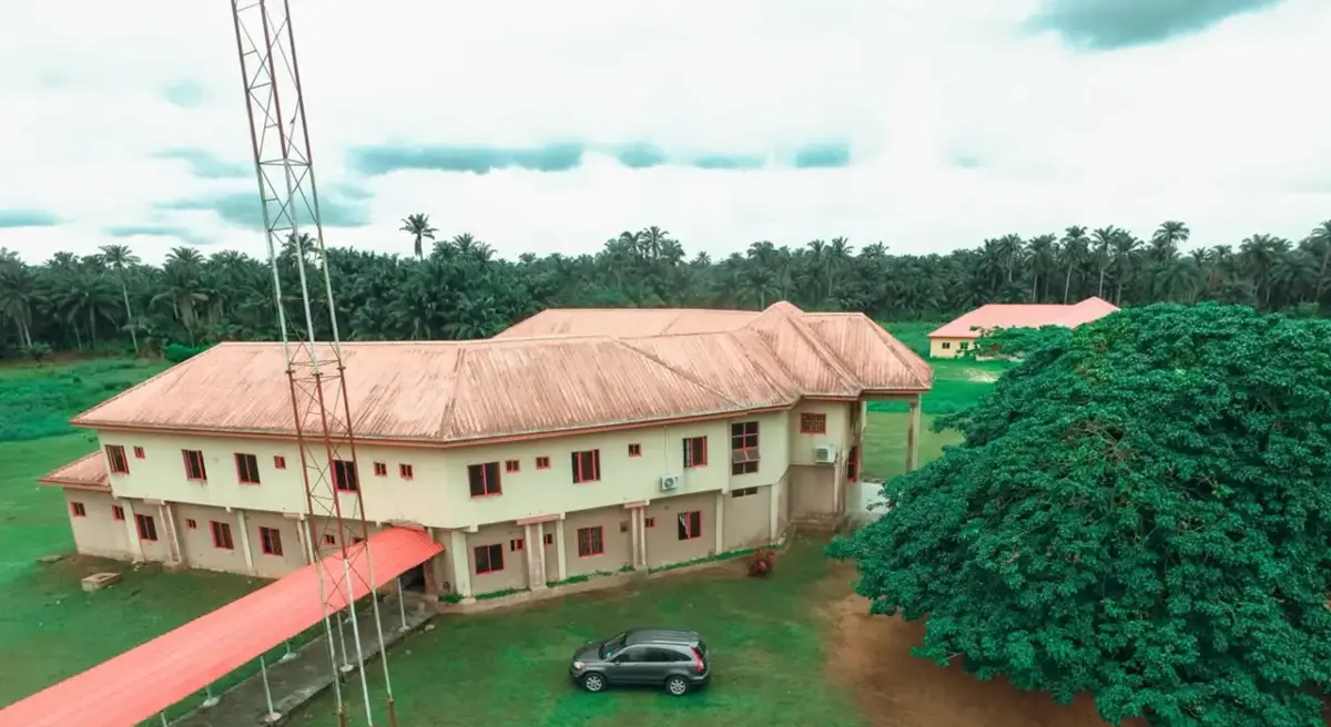 A two-storey public building set among palm trees