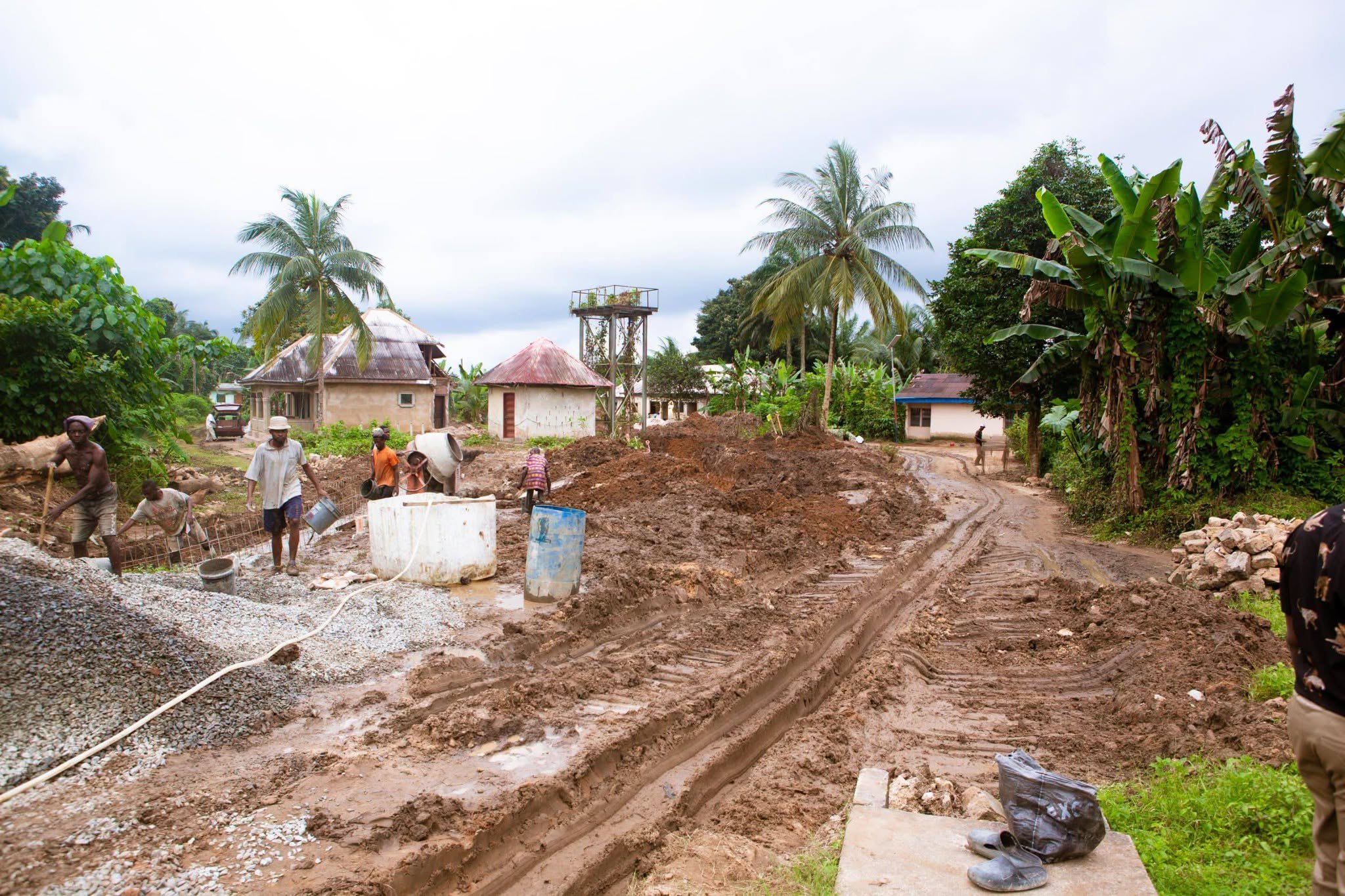 Workers laying drain reinforcement and gravel during construction