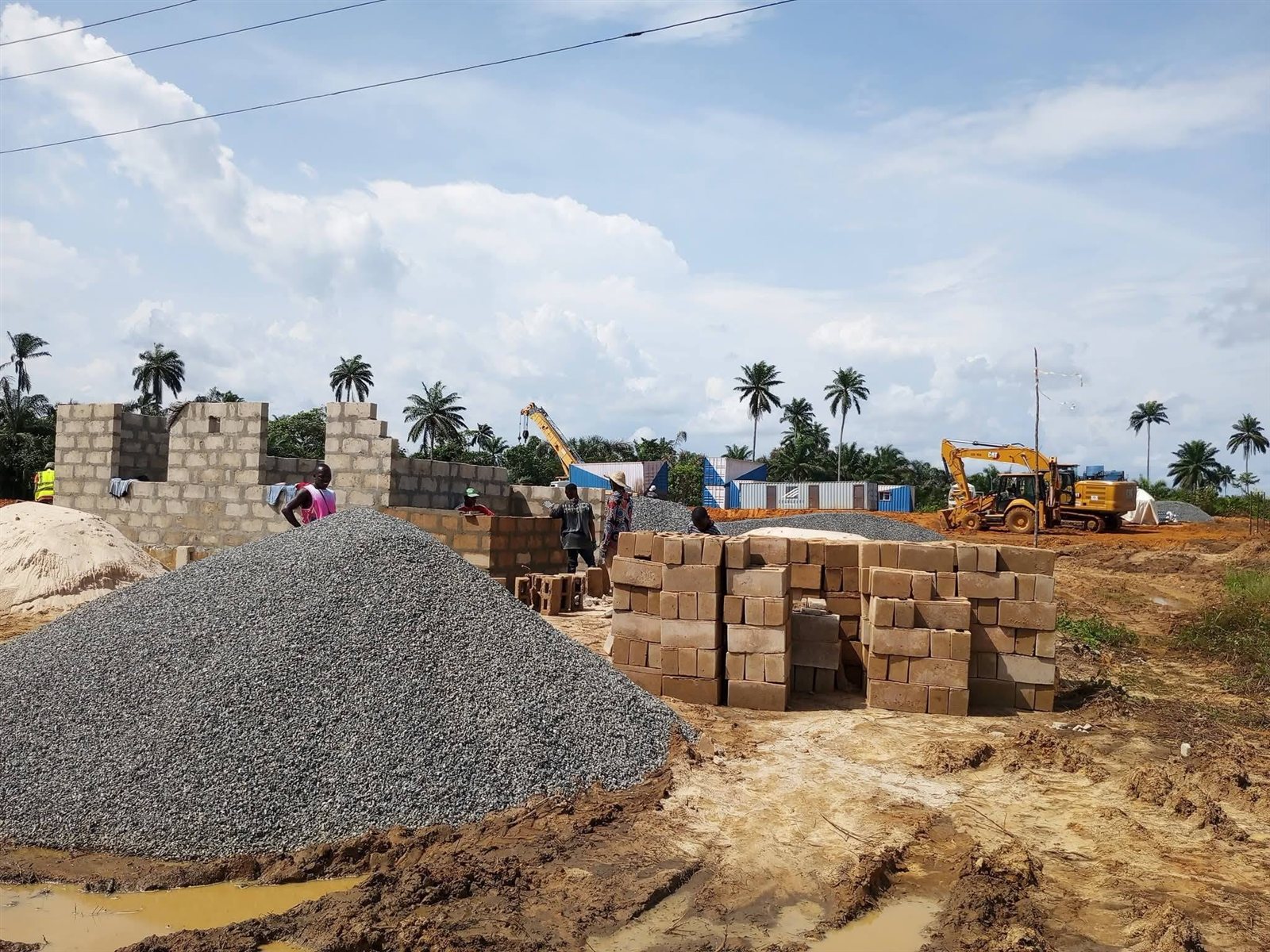 The contractor's site camp going up beside stockpiles of stone and blocks