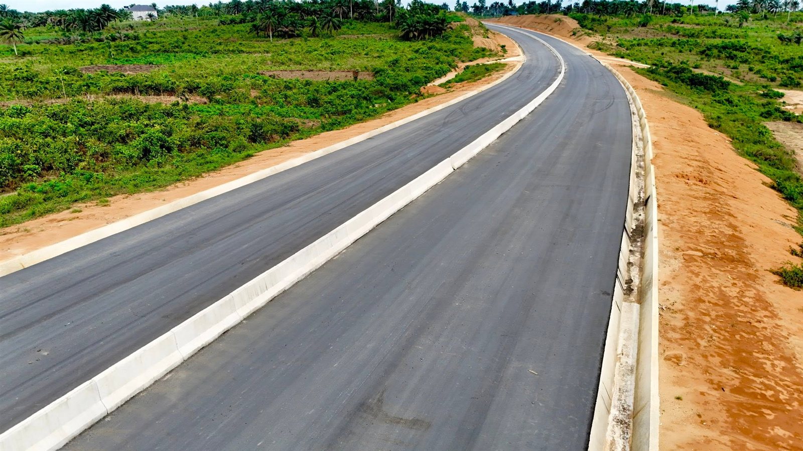 Close view of both carriageways with a concrete median and lined side drain