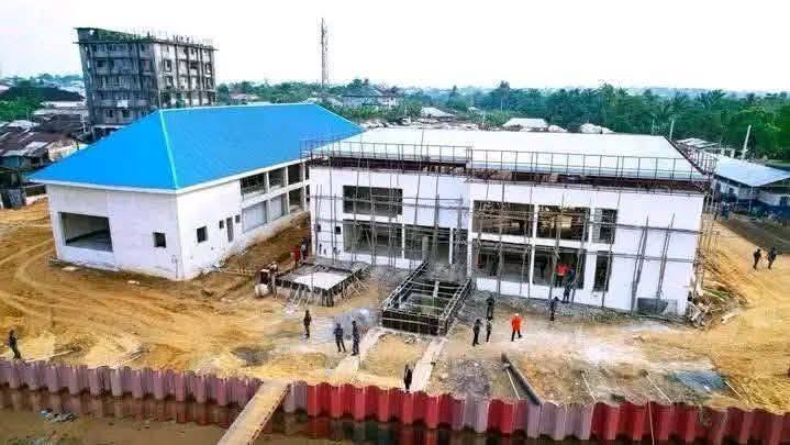 Terminal buildings under construction behind the shoreline sheet piling at Oron Beach