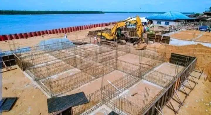 Excavator and reinforcement steel for building foundations beside the river at Oron Beach