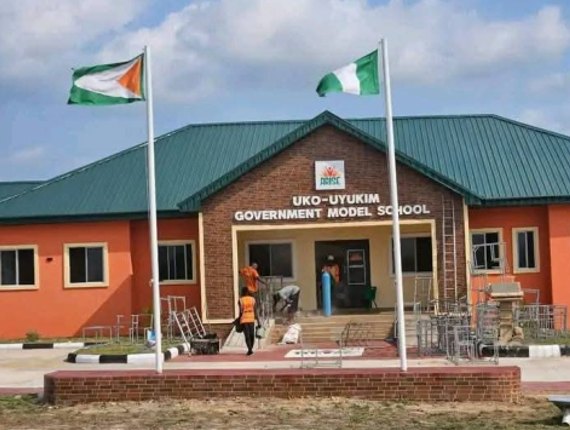 School entrance with flagpoles and green roof