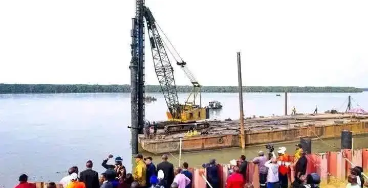 Barge with a crane working on the river at Oron.