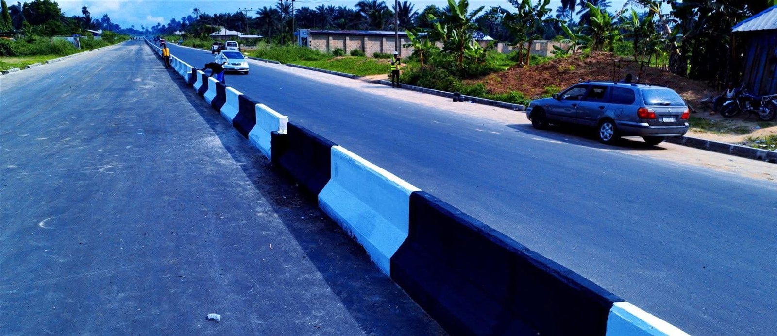 Finished asphalt lanes divided by a concrete median barrier