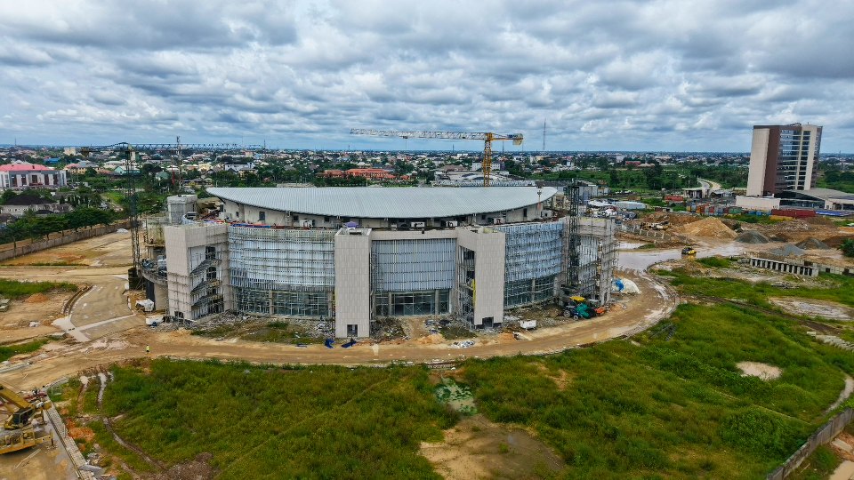 The hall with a tower crane beside it, seen from above