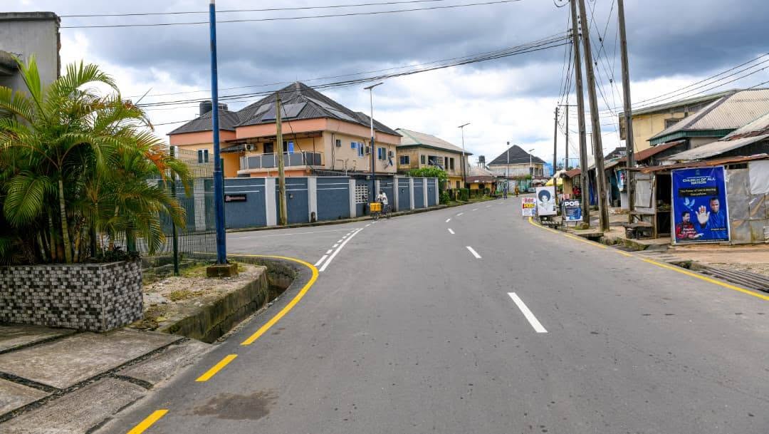 Curving new road with yellow edge lines past homes