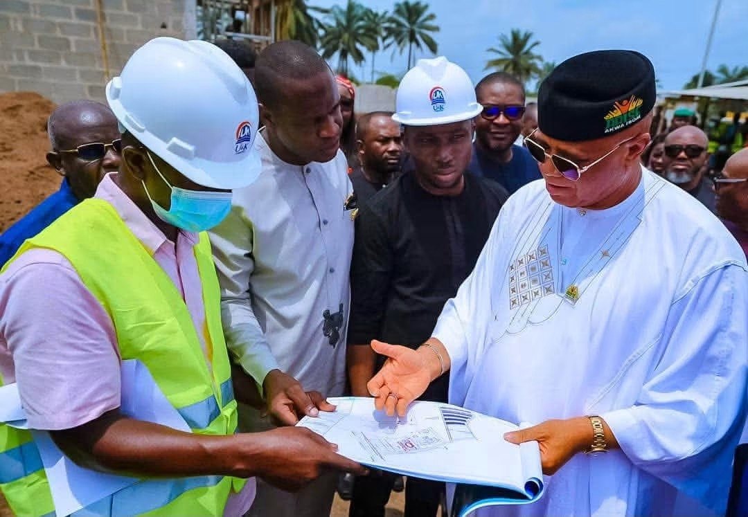 Governor Umo Eno looks over the plans with the builders