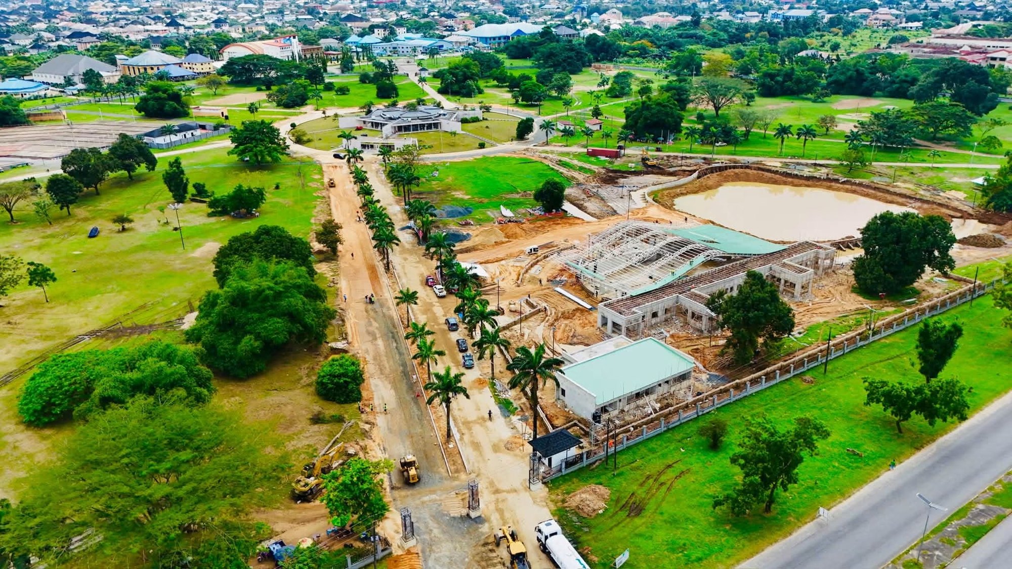 The new buildings beside the pond, with the Udo Udoma Avenue fence line